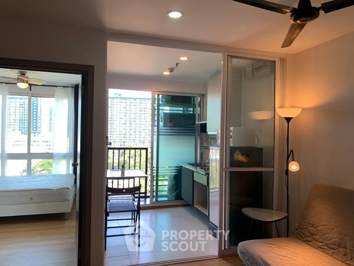 Modern apartment with open layout, featuring cozy living area and bright bedroom with city view.