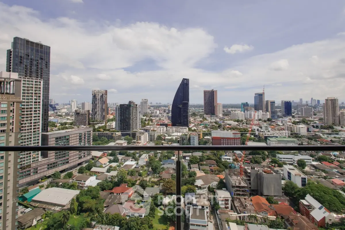Stunning cityscape view from a high-rise balcony showcasing urban skyline and lush greenery.