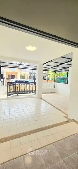 Spacious covered patio with tiled flooring and modern design