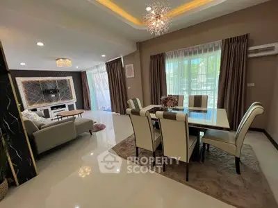 Luxurious open-plan living and dining area with elegant decor and ample natural light.