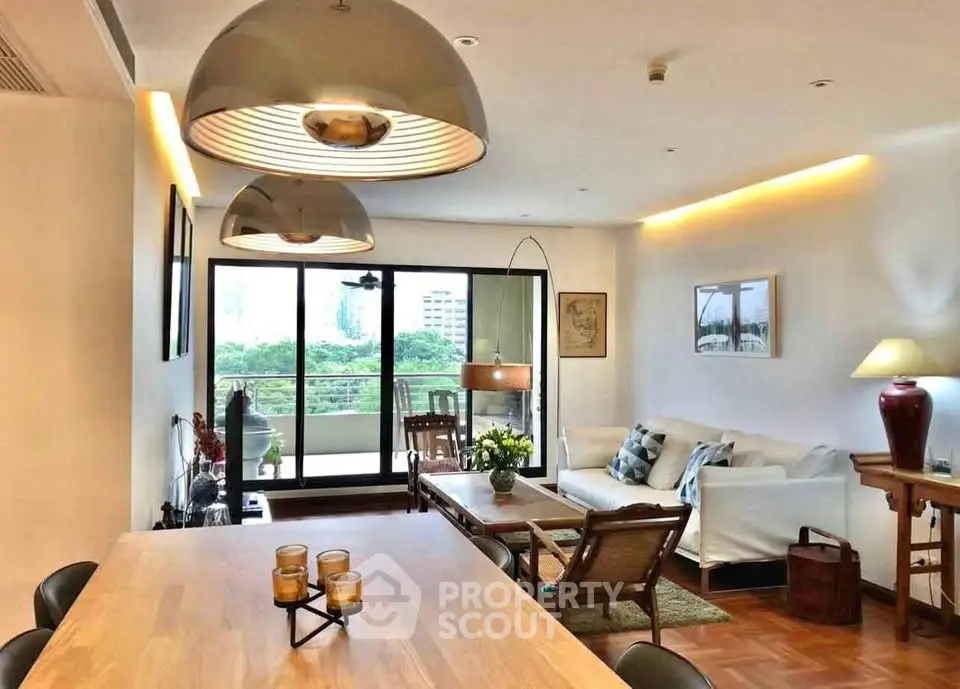 Spacious living room with modern decor and balcony view in upscale apartment.