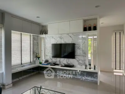 Modern living room with marble accent wall and sleek TV setup