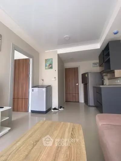 Modern apartment interior with sleek kitchen and cozy living area, perfect for urban living.