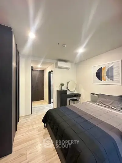 Modern bedroom with stylish decor and cozy ambiance, featuring a comfortable bed and elegant furnishings.