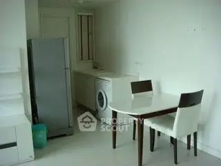 Modern kitchen with sleek appliances and dining area in a bright, minimalist design.