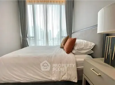 Modern bedroom with large window and stylish decor in a high-rise apartment.