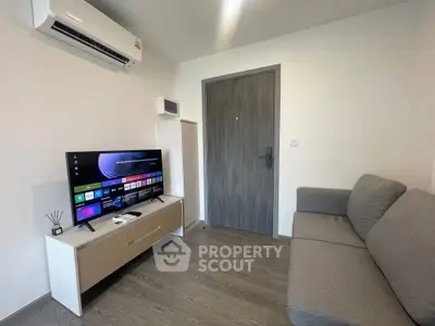 Modern living room with sleek furniture and smart TV, perfect for relaxation.