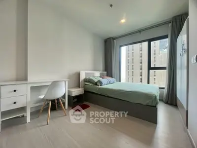 Modern bedroom with large window and minimalist decor in urban apartment