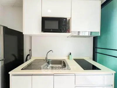 Modern compact kitchen with sleek appliances and minimalist design
