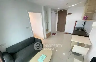 Modern compact living room with kitchenette in a cozy apartment