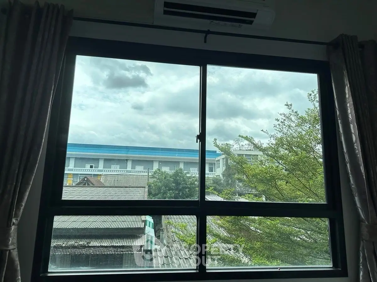 Scenic view from window with lush greenery and urban landscape