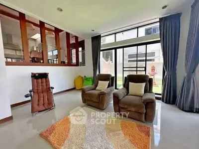 Spacious living room with plush seating and large windows for natural light.