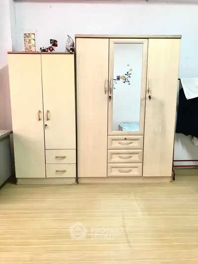 Spacious bedroom with modern wardrobe and ample storage space