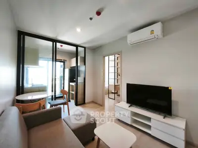 Modern living room with sleek furniture and open layout in a stylish apartment.