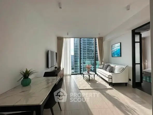 Modern living room with city view, elegant decor, and natural light.