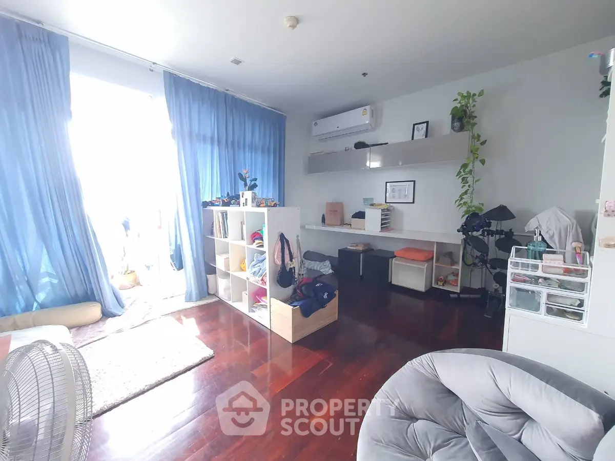 Spacious and bright living room with modern decor and large windows