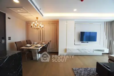 Luxurious modern living room with elegant dining area and wall-mounted TV, featuring stylish lighting and sleek design.
