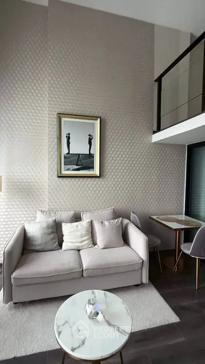Modern living room with high ceiling, elegant decor, and stylish furniture in a contemporary apartment.