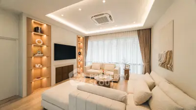 Luxurious modern living room with elegant lighting and plush seating, perfect for relaxation and entertainment.