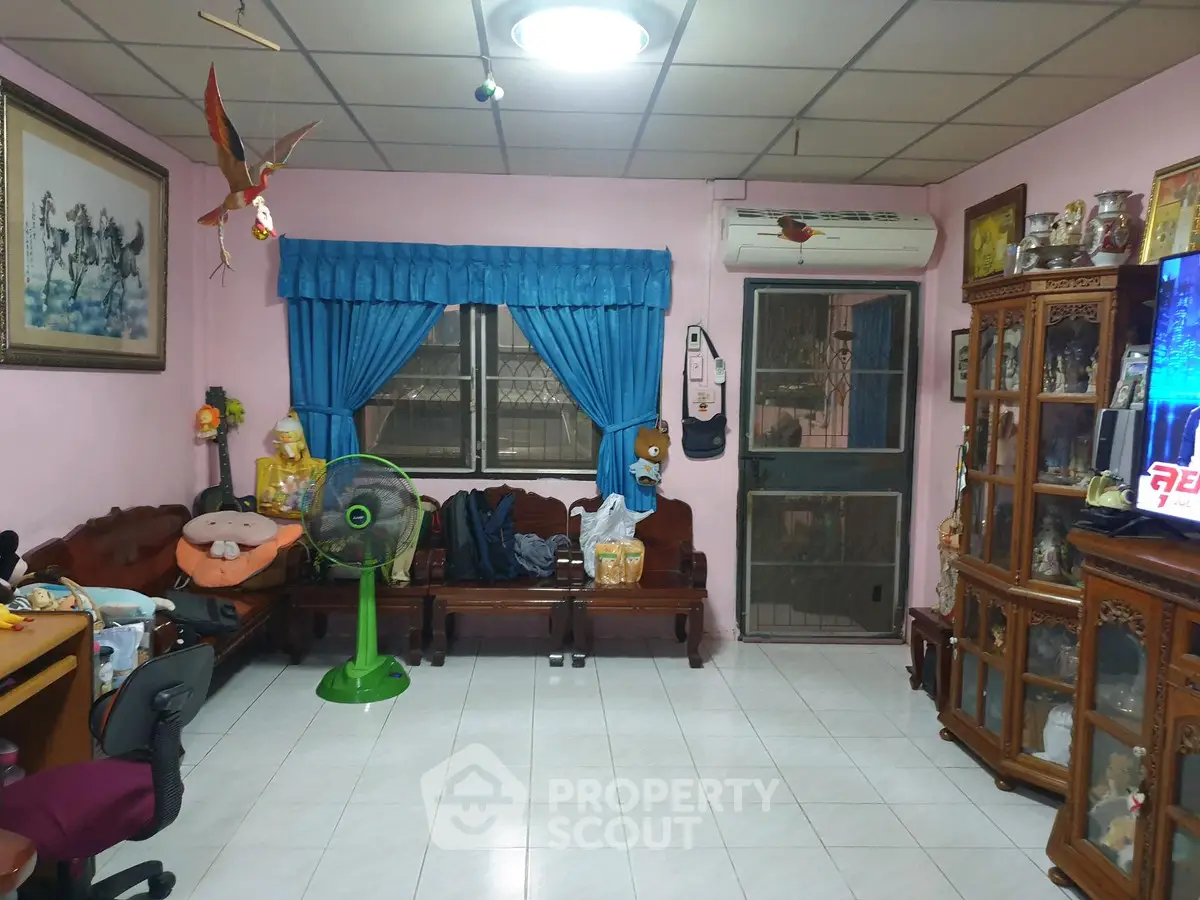 Charming living room with traditional decor and cozy seating area, perfect for relaxation and family gatherings.