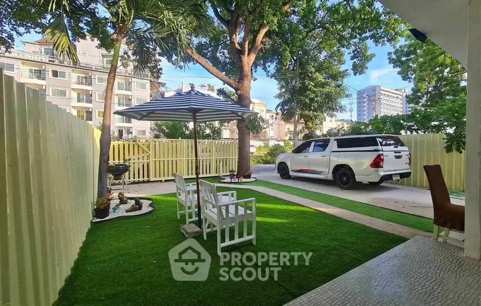 Charming garden with seating area and parking space in urban setting