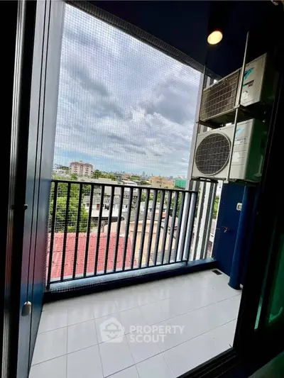 Modern balcony with city view and air conditioning units, perfect for urban living.