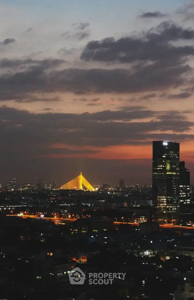 Stunning cityscape view with illuminated bridge and skyscrapers at sunset