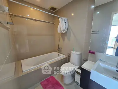 Modern bathroom with bathtub and sleek fixtures in a contemporary apartment.