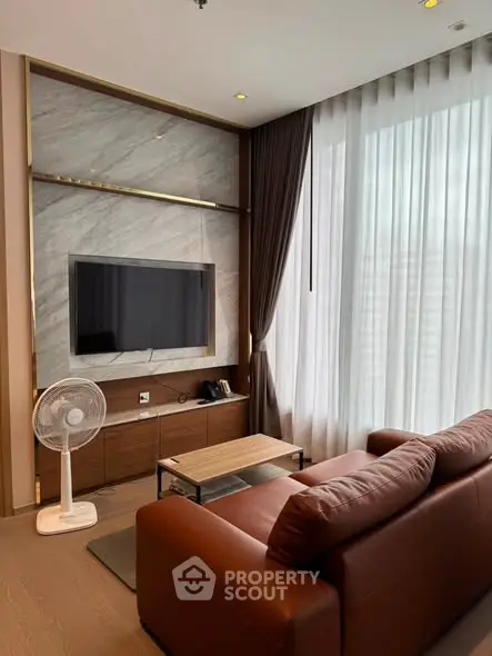 Modern living room with sleek TV setup and elegant curtains
