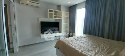 Modern bedroom with built-in TV and shelving, large window with curtains.