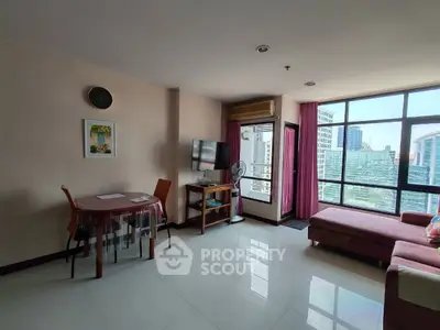 Spacious living room with large windows and city view in modern apartment.