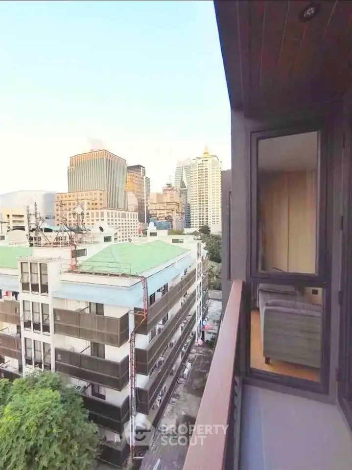 Stunning city view from a modern apartment balcony, showcasing urban skyline and vibrant surroundings.