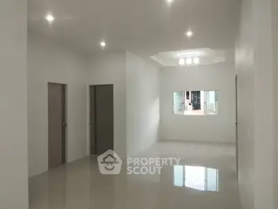 Spacious modern living area with natural light and sleek tile flooring