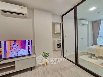 Modern apartment interior with glass partition, cozy bedroom, and sleek living area.