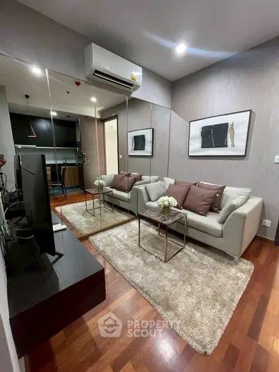 Modern living room with cozy sofa, stylish decor, and hardwood floors in a contemporary apartment.