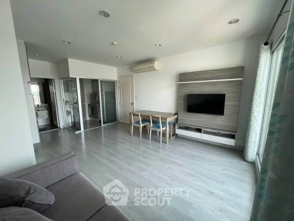 Spacious modern living room with sleek flooring and stylish furniture in a contemporary apartment.