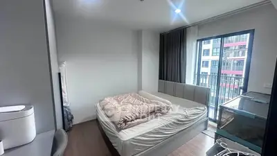 Modern bedroom with balcony view in urban apartment