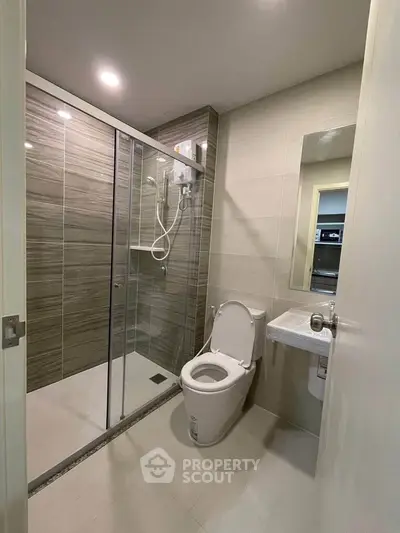 Modern bathroom with glass shower enclosure and sleek design