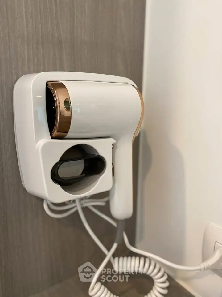 Modern wall-mounted hairdryer in a stylish bathroom setting.