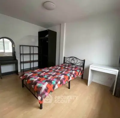 Cozy bedroom with single bed, modern decor, and ample natural light.