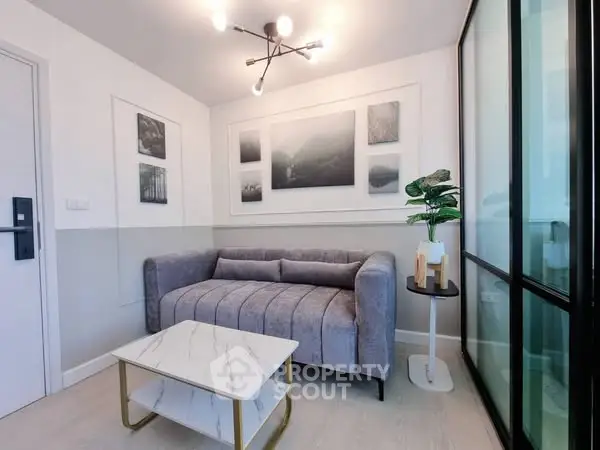 Modern living room with stylish gray sofa and marble coffee table