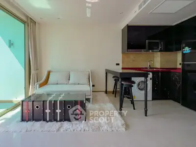Modern living room with sleek furniture and integrated kitchen appliances, featuring a stylish open layout.