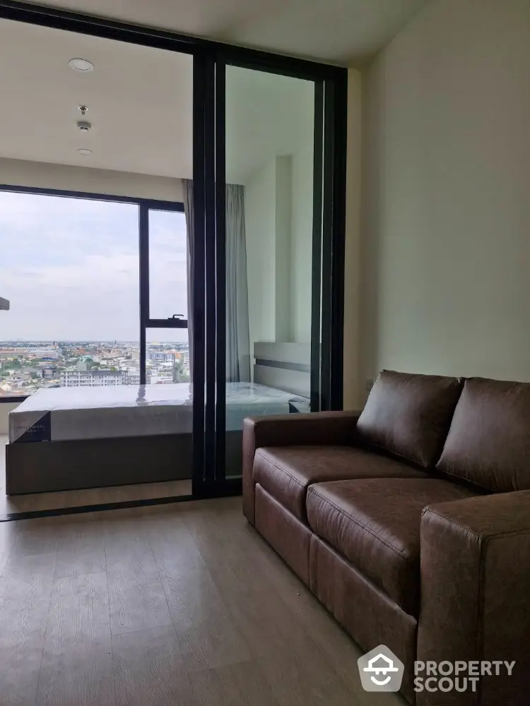 Modern living room with leather sofa and city view balcony