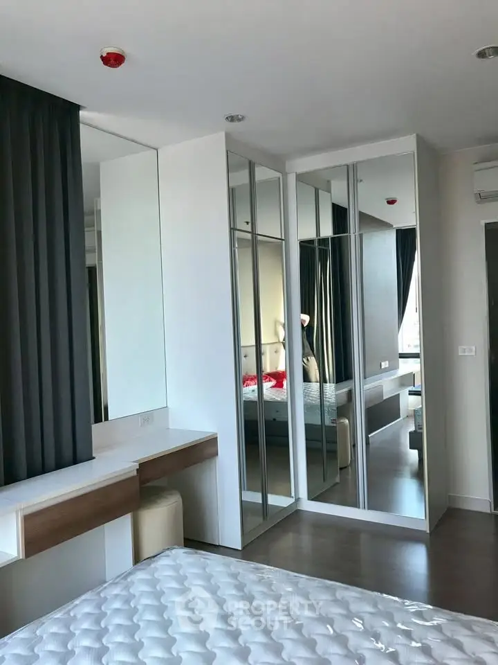 Modern bedroom with mirrored wardrobe and stylish decor