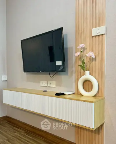 Modern living room with wall-mounted TV and stylish decor