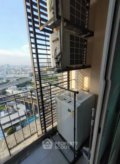 High-rise balcony with washing machine and city view, perfect for urban living convenience.