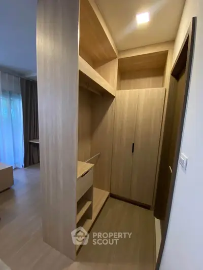 Spacious walk-in closet with modern wooden shelving and ample storage space.