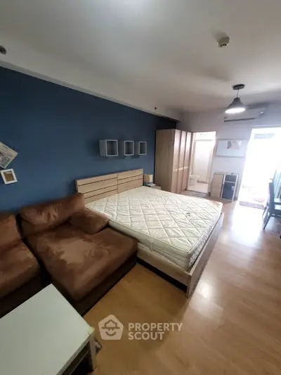 Spacious bedroom with modern furnishings and ample natural light