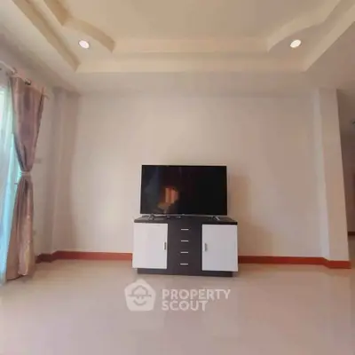 Spacious living room with modern TV stand and elegant ceiling design