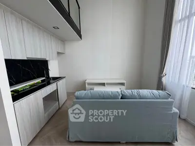 Modern living room with sleek kitchen and cozy sofa in bright apartment